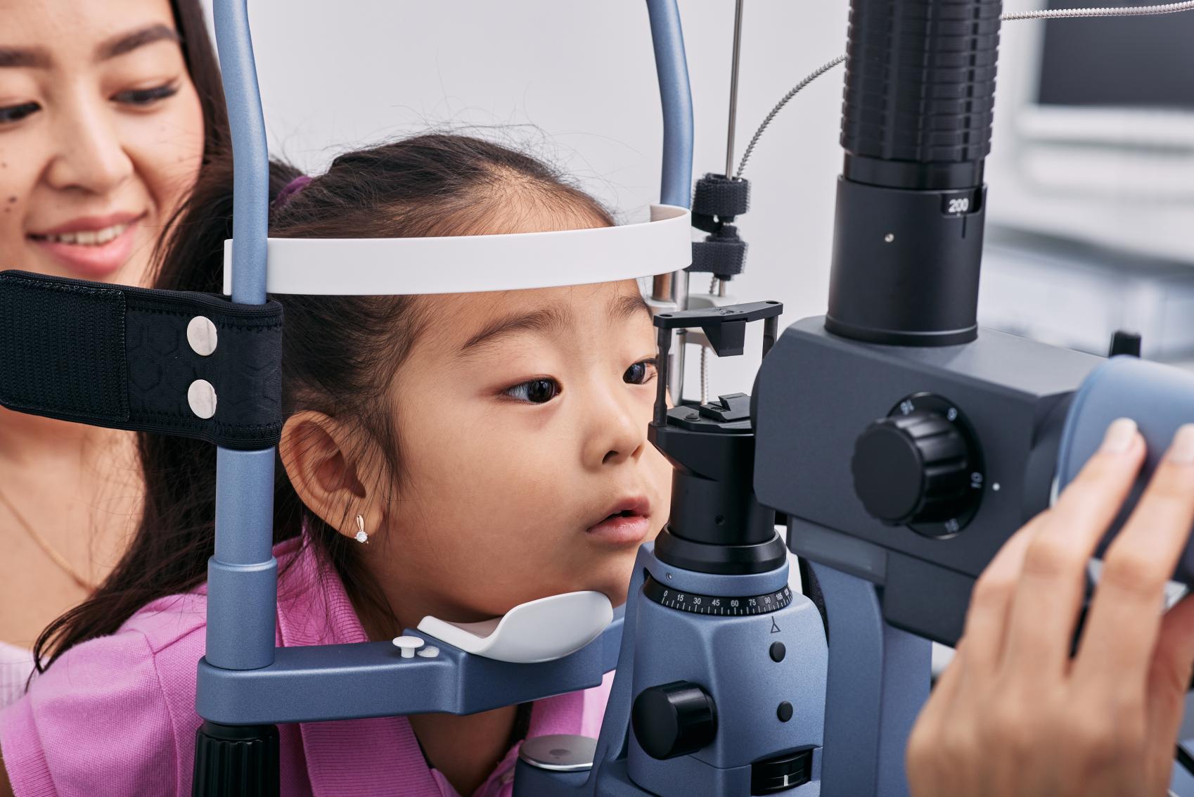 Young girl at the optometrist having her eyes tested.